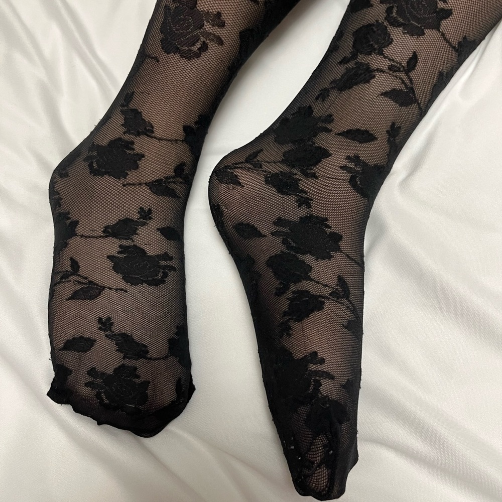 Floral black pantyhose tights. Worn a few times but still in great shape.